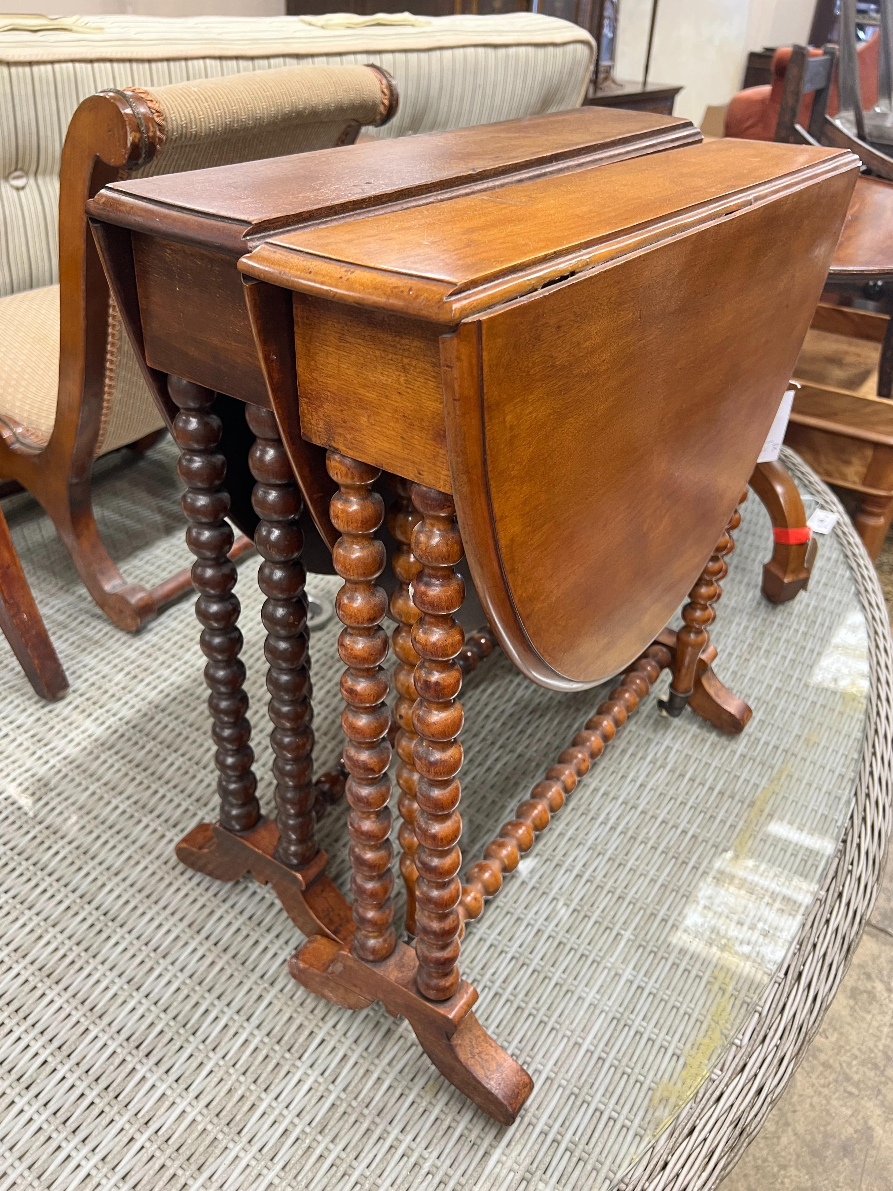 A near pair of Victorian mahogany bobbin turned Sutherland tables, width 60cm, depth 13cm, height 60cm